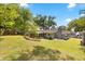 Expansive backyard with a chicken coop, tiered garden, and screened porch, perfect for entertaining at 7115 Lake Ola Dr, Mount Dora, FL 32757