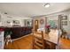 Open-concept dining room flows into living area and features hardwood floors and lake views at 7115 Lake Ola Dr, Mount Dora, FL 32757