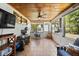 Inviting sun room with tile floors, wood ceilings, lots of windows, and a view of the outdoors at 7115 Lake Ola Dr, Mount Dora, FL 32757