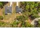 Aerial view of two houses with mature trees, landscaping and driveways at 814 Olive Ave, Fruitland Park, FL 34731