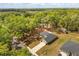 An aerial view shows this home with a stone driveway surrounded by mature landscaping on a sunny day at 814 Olive Ave, Fruitland Park, FL 34731