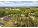 Aerial view of a home surrounded by mature trees and large grass area at 814 Olive Ave, Fruitland Park, FL 34731