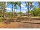 Wide view of backyard with mature trees, showing the house, shed and boat at 814 Olive Ave, Fruitland Park, FL 34731