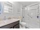 Modern bathroom featuring a glass-enclosed shower with grab bars and a vanity with sink at 814 Olive Ave, Fruitland Park, FL 34731
