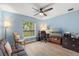 Inviting bedroom showcasing soft blue walls, natural light, and hardwood floors at 814 Olive Ave, Fruitland Park, FL 34731