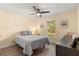 Cozy bedroom with natural light, a ceiling fan, and neutral decor at 814 Olive Ave, Fruitland Park, FL 34731