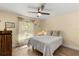 Comfortable bedroom with a bright window and natural light, complemented by stylish curtains at 814 Olive Ave, Fruitland Park, FL 34731