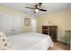 Cozy bedroom showcases a ceiling fan, stylish decor, and comfortable furnishings at 814 Olive Ave, Fruitland Park, FL 34731