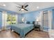 Inviting bedroom with blue walls, a large window, and stylish bedside tables and lamps at 814 Olive Ave, Fruitland Park, FL 34731