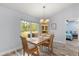 Bright dining room featuring a wooden table with a window view and hardwood floors at 814 Olive Ave, Fruitland Park, FL 34731