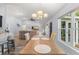 Bright dining room featuring a modern chandelier and view into the living room at 814 Olive Ave, Fruitland Park, FL 34731
