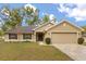 Charming single-story home with a well-maintained lawn, neutral paint and inviting curb appeal at 814 Olive Ave, Fruitland Park, FL 34731