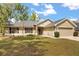 Well-kept single-story home featuring a manicured lawn and inviting exterior at 814 Olive Ave, Fruitland Park, FL 34731