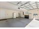 Spacious garage offering ample storage, a utility sink, and epoxy flooring at 814 Olive Ave, Fruitland Park, FL 34731