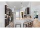 Modern kitchen featuring stainless steel appliances, dark cabinets, and granite countertops at 814 Olive Ave, Fruitland Park, FL 34731