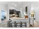 Open kitchen with granite countertops, breakfast bar, and modern dark wood cabinets at 814 Olive Ave, Fruitland Park, FL 34731
