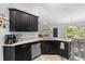 Open kitchen area featuring a breakfast bar, stainless steel appliances, and granite countertops at 814 Olive Ave, Fruitland Park, FL 34731