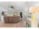 Bright living room featuring a comfortable curved couch and a ceiling fan at 814 Olive Ave, Fruitland Park, FL 34731