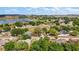 Scenic aerial view of a quiet suburban community with lush green spaces and a tranquil lake at 831 Whisper Sound, Minneola, FL 34715