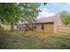 Exterior shot of backyard with screened porch, green grass, and partial fence at 831 Whisper Sound, Minneola, FL 34715