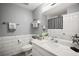 Clean bathroom with white vanity, decorative shower curtain, and tile accent at 831 Whisper Sound, Minneola, FL 34715
