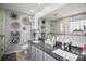 Modern bathroom with a double sink vanity, granite countertop, and decorative wall art at 831 Whisper Sound, Minneola, FL 34715