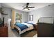 Comfortable bedroom with a ceiling fan and large window providing plenty of natural light at 831 Whisper Sound, Minneola, FL 34715