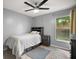 Well-lit bedroom featuring wood-look floors, dresser and ceiling fan at 831 Whisper Sound, Minneola, FL 34715