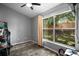 A bedroom with a large window offering backyard views at 831 Whisper Sound, Minneola, FL 34715
