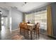 Inviting dining area with large windows, natural lighting, and seating for six at 831 Whisper Sound, Minneola, FL 34715