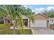 Single-Gathering home with two-car garage, manicured lawn, and curb appeal at 831 Whisper Sound, Minneola, FL 34715