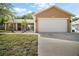 Charming single-story home with well-manicured lawn, two-car garage, and neutral paint at 831 Whisper Sound, Minneola, FL 34715
