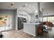 Modern kitchen with stainless steel appliances, white cabinets, and a view into the dining area at 831 Whisper Sound, Minneola, FL 34715