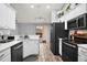 Bright kitchen with modern stainless steel appliances, white cabinets, and tile flooring at 831 Whisper Sound, Minneola, FL 34715