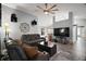 Spacious living room featuring tile flooring, modern ceiling fan and comfortable leather couches at 831 Whisper Sound, Minneola, FL 34715