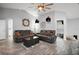 Bright living room with tile floors, ceiling fan, two leather sofas, and decorative accents at 831 Whisper Sound, Minneola, FL 34715