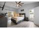 Comfortable bedroom featuring a ceiling fan, sliding glass doors, and a modern aesthetic at 831 Whisper Sound, Minneola, FL 34715