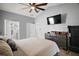 Beautiful bedroom featuring wood-look floors, dresser, ceiling fan, and walk-in closet at 831 Whisper Sound, Minneola, FL 34715
