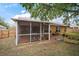 View of screened-in patio with barbecue grill and access to the yard with brick pavers and garden at 831 Whisper Sound, Minneola, FL 34715