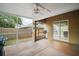 Spacious screened porch with ceiling fan, concrete floor, and sliding glass doors to the interior at 831 Whisper Sound, Minneola, FL 34715