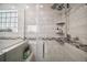 Updated shower with multiple shower heads, glass door and decorative tile at 831 Whisper Sound, Minneola, FL 34715