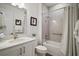 This is a bathroom featuring a shower-tub combo, a granite vanity with a sink, and neutral-toned decor at 8433 Sw 98Th Terrace Rd, Ocala, FL 34481