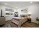 Charming bedroom with hardwood floors, a cozy bed, and a bright window view at 8433 Sw 98Th Terrace Rd, Ocala, FL 34481