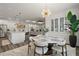 Bright dining area features a white table with seating for six and a modern light fixture at 8433 Sw 98Th Terrace Rd, Ocala, FL 34481