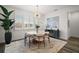 The dining room features a modern light fixture and a large window with shutters at 8433 Sw 98Th Terrace Rd, Ocala, FL 34481