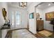 Bright foyer with decorative glass door, wood floors, and elegant console table at 8433 Sw 98Th Terrace Rd, Ocala, FL 34481