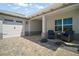Attached two-car garage and covered patio with comfortable seating for relaxing outdoors at 8433 Sw 98Th Terrace Rd, Ocala, FL 34481
