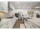 This kitchen features a stainless steel refrigerator and a kitchen island with a sink at 8433 Sw 98Th Terrace Rd, Ocala, FL 34481