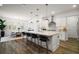 Open-concept kitchen boasts a large island with seating and modern stainless steel appliances at 8433 Sw 98Th Terrace Rd, Ocala, FL 34481