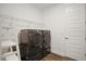 This is a well-equipped laundry room with a washer, dryer, shelving, and ample space for laundry tasks at 8433 Sw 98Th Terrace Rd, Ocala, FL 34481